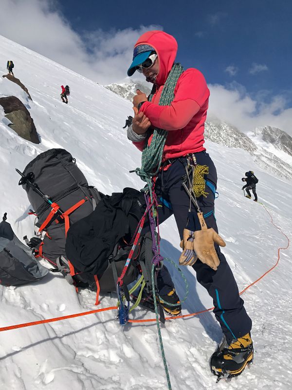 05A Climbers Continue Climbing While Guide Pachi Ibarra Rests In The Rock Band On The Climb Up The Fixed Ropes To High Camp
